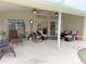 Relaxing patio with seating area and pool access at 273 Mark Twain Ln, Rotonda West, FL 33947