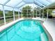 Inviting pool area with spa and screened enclosure at 273 Mark Twain Ln, Rotonda West, FL 33947