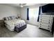 Bright bedroom with a queen-size bed, gray ottoman, and white dresser at 2801 Magdalina Dr # 1A, Punta Gorda, FL 33950