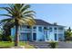 Light blue two-story building with balconies and palm trees at 2801 Magdalina Dr # 1A, Punta Gorda, FL 33950