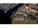 Aerial view showcasing waterfront property, private boat dock, and community pool at 3335 Purple Martin Dr # 6, Punta Gorda, FL 33950