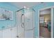 Corner shower with glass enclosure and pebble flooring at 3335 Purple Martin Dr # 6, Punta Gorda, FL 33950