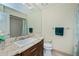 Bathroom with granite countertop, dark brown vanity, and teal shower curtain at 3335 Purple Martin Dr # 6, Punta Gorda, FL 33950