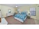 Bedroom with white wicker furniture and blue bedding at 3335 Purple Martin Dr # 6, Punta Gorda, FL 33950