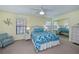 Bedroom with white wicker furniture and blue bedding at 3335 Purple Martin Dr # 6, Punta Gorda, FL 33950