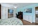 Bright bedroom with a tropical themed wall and built-in cabinets at 3335 Purple Martin Dr # 6, Punta Gorda, FL 33950