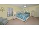 Bedroom with white wicker furniture and blue bedding at 3335 Purple Martin Dr # 6, Punta Gorda, FL 33950