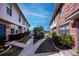 Courtyard with brick and stucco buildings, walkways, and landscaping at 3335 Purple Martin Dr # 6, Punta Gorda, FL 33950