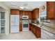 Bright kitchen with granite countertops, wood cabinets, and stainless steel appliances at 3335 Purple Martin Dr # 6, Punta Gorda, FL 33950