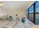 Living room with comfortable seating, large windows, and pool view at 3335 Purple Martin Dr # 6, Punta Gorda, FL 33950