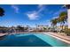 Community pool with canal views and surrounding palm trees at 3335 Purple Martin Dr # 6, Punta Gorda, FL 33950