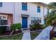 Townhouse exterior with blue door and landscaping at 3335 Purple Martin Dr # 6, Punta Gorda, FL 33950