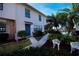 Townhouse with blue door and walkway, nestled in landscaping at 3335 Purple Martin Dr # 6, Punta Gorda, FL 33950