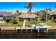 Aerial view of canal-front home with dock and boat at 343 Portofino Dr, Punta Gorda, FL 33950