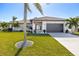 White house with gray garage door, landscaping, and American flag at 343 Portofino Dr, Punta Gorda, FL 33950