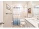 Bathroom with tub shower combo, white vanity, and blue accents at 3495 Levee St, North Port, FL 34288