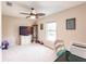Bedroom with ceiling fan, TV, and window with natural light at 3495 Levee St, North Port, FL 34288