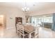 Bright dining room with chandelier and view to backyard at 3495 Levee St, North Port, FL 34288
