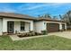 Front entry with a three-car garage and paver driveway at 3495 Levee St, North Port, FL 34288