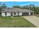 House with a three-car garage and paver driveway at 3495 Levee St, North Port, FL 34288