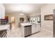 Open concept kitchen with island, stainless steel appliances, and white cabinets at 3495 Levee St, North Port, FL 34288