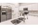 Modern kitchen with stainless steel sink and white cabinets at 3495 Levee St, North Port, FL 34288