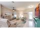Living room featuring comfy seating and a large TV at 3495 Levee St, North Port, FL 34288