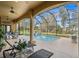 Relaxing screened pool area with lounge chairs and outdoor dining at 387 Hallcrest Ter, Port Charlotte, FL 33954