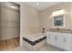 Bathroom features a soaking tub, vanity with granite countertop, and walk-in closet at 4629 Enid Ln, North Port, FL 34288