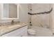 Bathroom with granite countertop, white vanity, and bathtub shower combo at 4629 Enid Ln, North Port, FL 34288