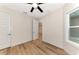 Spacious bedroom with hardwood floors, ceiling fan, and access to another room at 4629 Enid Ln, North Port, FL 34288