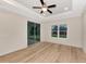 Bright bedroom with a window, ceiling fan, and hardwood floors at 4629 Enid Ln, North Port, FL 34288