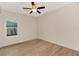 Well-lit bedroom featuring hardwood floors and a ceiling fan at 4629 Enid Ln, North Port, FL 34288