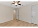 Bedroom with hardwood floors, ceiling fan, and an adjacent room at 4629 Enid Ln, North Port, FL 34288
