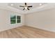 Well-lit bedroom featuring a large window and hardwood floors at 4629 Enid Ln, North Port, FL 34288