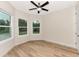 Bright bedroom with hardwood floors, ceiling fan, and multiple windows at 4629 Enid Ln, North Port, FL 34288