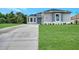 New construction home featuring a gray exterior and concrete driveway at 4629 Enid Ln, North Port, FL 34288