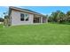 View of the home's exterior, showcasing a spacious backyard and landscaping at 4629 Enid Ln, North Port, FL 34288