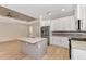 Modern kitchen featuring white cabinets, granite countertops, and stainless steel appliances at 4629 Enid Ln, North Port, FL 34288