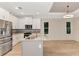 Modern kitchen with white cabinets, granite countertops, and stainless steel appliances at 4629 Enid Ln, North Port, FL 34288