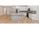 Modern kitchen with white cabinets, granite countertops, and a large island at 4629 Enid Ln, North Port, FL 34288