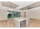 Modern kitchen with island, stainless steel appliances, and light-colored cabinetry at 4629 Enid Ln, North Port, FL 34288