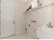 Laundry room with utility sink, shelving, and a door at 4629 Enid Ln, North Port, FL 34288