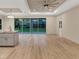 Living area with sliding glass doors, kitchen island, and hardwood floors at 4629 Enid Ln, North Port, FL 34288
