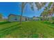 Large backyard with grassy area and lush landscaping at 5049 Birdsong St, North Port, FL 34291
