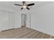 Spacious bedroom with ceiling fan, double doors and light wood flooring at 5049 Birdsong St, North Port, FL 34291