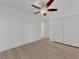 Spacious bedroom with ceiling fan, double doors and light wood flooring at 5049 Birdsong St, North Port, FL 34291