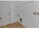 Bright laundry room with built-in shelving and vinyl flooring at 5049 Birdsong St, North Port, FL 34291