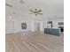 Open concept living room and kitchen with light wood floors at 5049 Birdsong St, North Port, FL 34291