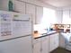 Bright kitchen with white cabinets, laminate countertops, and appliances at 5232 Palena Blvd, North Port, FL 34287
